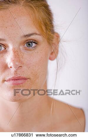 Studio portrait of young woman with freckles View Large Photo Image Stock Image - Studio portrait of young woman with freckles. Fotosearch
