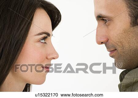 Studio profile of couple looking in eyes face to face View Large Photo Image Stock Image - Studio profile of couple looking in eyes face to face. Fotosearch