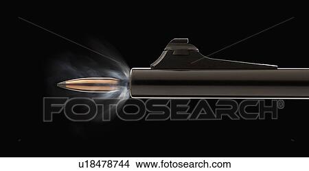 Picture - Studio shot of bullet coming out of gun barrel. Fotosearch