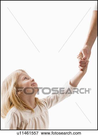Studio shot of girl (2-3) holding adult's hand View Large Photo Image Stock Photo - Studio shot of girl (2-3) holding adult's hand. Fotosearch