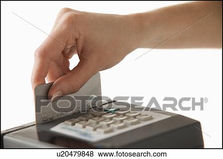 Stock Photo - Studio shot of hand using credit card. Fotosearch
