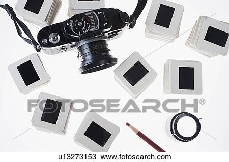 Stock Image - Studio Shot of slides and camera. Fotosearch