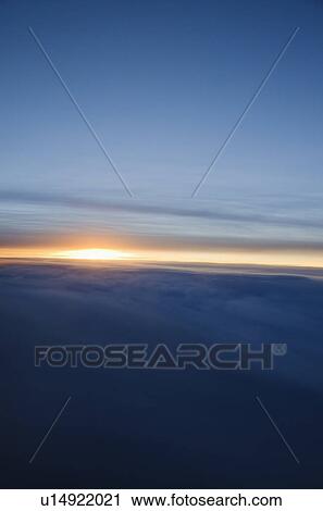 Stock Image - Sunrise over clouds. Fotosearch