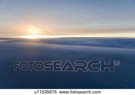 Sunrise over clouds View Large Photo Image Stock Photography - Sunrise over clouds. Fotosearch