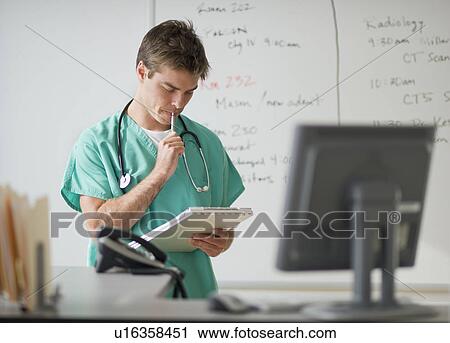 Stock Image - Surgeon working in office. Fotosearch