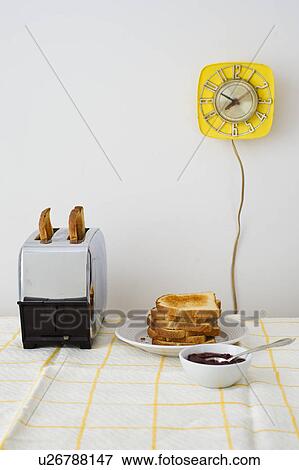 Toast in toaster on breakfast table View Large Photo Image Stock Photo - Toast in toaster on breakfast table. Fotosearch