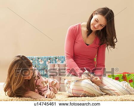 Two sisters (6-7, 18-19) wrapping Christmas presents View Large Photo Image Stock Image - Two sisters (6-7, 18-19) wrapping Christmas presents. Fotosearch