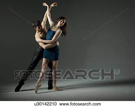Stock Image - Two young ballet dancers, studio shot. Fotosearch