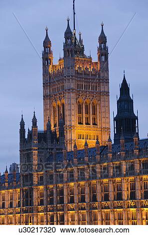 Stock Image - United Kingdom, London, Houses of Parliament illuminated at dusk. Fotosearch
