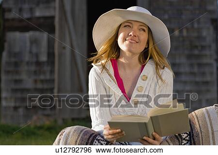 USA, California, Bolinas, Young woman reading book outdoors View Large Photo Image Stock Photograph - USA, California, Bolinas, Young woman reading book outdoors. Fotosearch