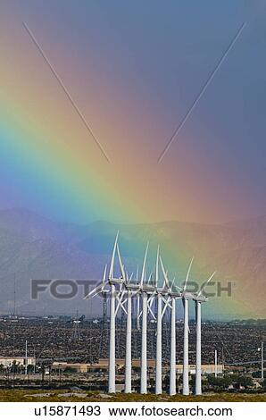 Stock Image - USA, California, Palm Springs, rainbow over wind turbines. Fotosearch