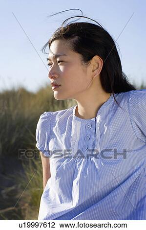 USA, California, Point Reyes, Young woman sitting in grass on sand dune View Large Photo Image Stock Image - USA, California, Point Reyes, Young woman sitting in grass on sand dune. Fotosearch