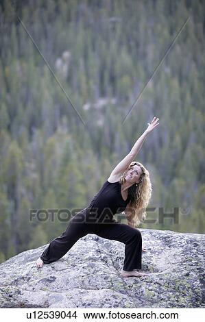 USA, Colorado, Aspen, woman stretching on rock View Large Photo Image Picture - USA, Colorado, Aspen, woman stretching on rock. Fotosearch