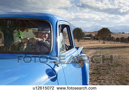USA, Colorado, Carbondale, Cowgirl driving old fashioned pickup truck in field View Large Photo Image Stock Image - USA, Colorado, Carbondale, Cowgirl driving old fashioned pickup truck in field. Fotosearch