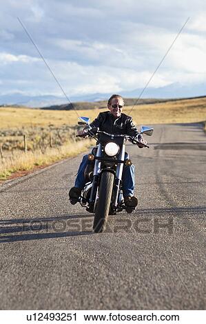 USA, Colorado, Carbondale, Mature man driving motorcycle View Large Photo Image Stock Image - USA, Colorado, Carbondale, Mature man driving motorcycle. Fotosearch