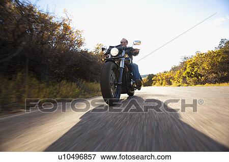 USA, Colorado, Carbondale, Mature man driving motorcycle View Large Photo Image Stock Photo - USA, Colorado, Carbondale, Mature man driving motorcycle. Fotosearch