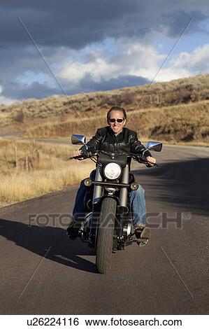 USA, Colorado, Carbondale, Mature man driving motorcycle View Large Photo Image Stock Photograph - USA, Colorado, Carbondale, Mature man driving motorcycle. Fotosearch