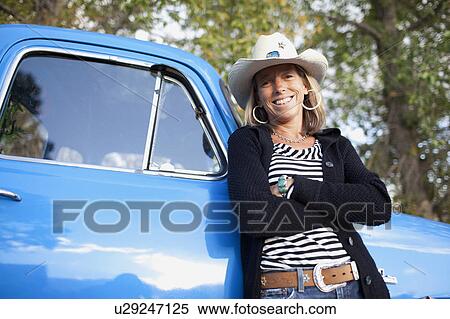USA, Colorado, Carbondale, Portrait of cowgirl with old fashioned pickup truck View Large Photo Image Stock Photography - USA, Colorado, Carbondale, Portrait of cowgirl with old fashioned pickup truck. Fotosearch