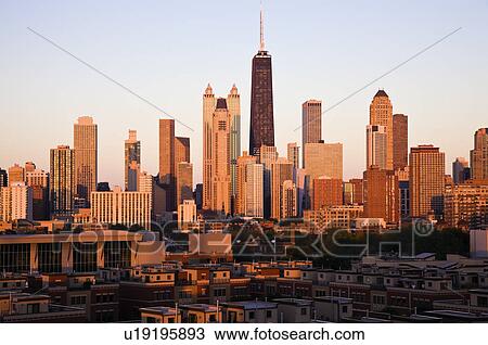 Stock Image - USA, Illinois, Chicago, City skyline at sunset. Fotosearch