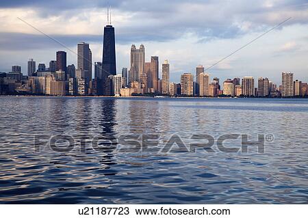Stock Image - USA, Illinois, Chicago, City skyline over Lake Michigan. Fotosearch