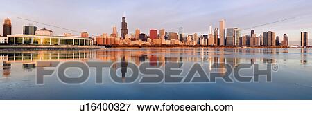 Stock Photo - USA, Illinois, Chicago, City skyline over Lake Michigan at sunrise. Fotosearch
