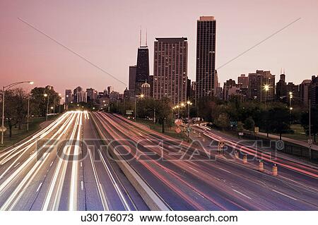 Stock Image - USA, Illinois, Chicago, highway at dusk. Fotosearch