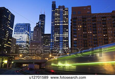 USA, Illinois, Chicago, night cityscape with train View Large Photo Image Stock Photo - USA, Illinois, Chicago, night cityscape with train. Fotosearch