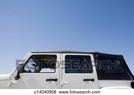 Stock Photo - USA, Massachusetts, close up of jeep against blue sky. Fotosearch