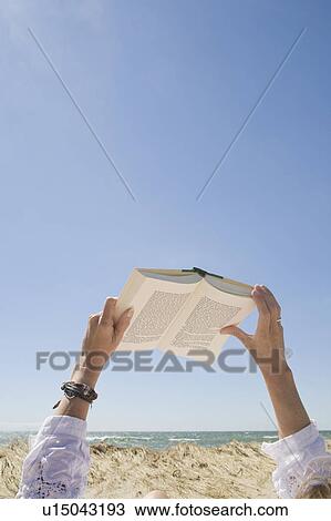 USA, Massachusetts, woman's hands on beach holding book View Large Photo Image Stock Image - USA, Massachusetts, woman's hands on beach holding book. Fotosearch