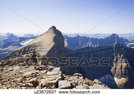 USA, Montana, Glacier National Park, Hikers taking pictures at top of Mt Siyeah View Large Photo Image Stock Photo - USA, Montana, Glacier National Park, Hikers taking pictures at top of Mt Siyeah. Fotosearch