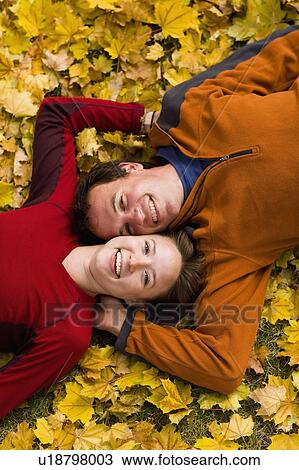 Stock Image - USA, Montana, Kalispell, Happy couple embracing in autumn. Fotosearch