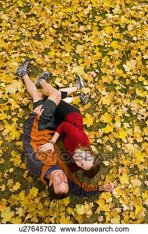 Stock Image - USA, Montana, Kalispell, Happy couple embracing in autumn. Fotosearch