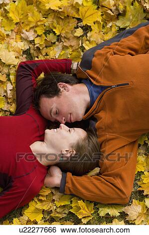 Stock Photograph - USA, Montana, Kalispell, Happy couple embracing in autumn. Fotosearch