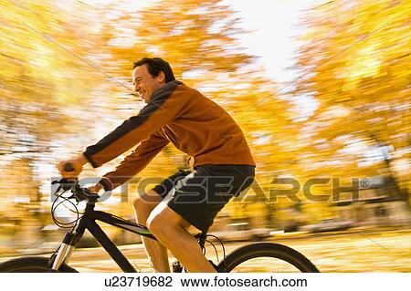 USA, Montana, Kalispell, Mid adult man cycling View Large Photo Image Stock Image - USA, Montana, Kalispell, Mid adult man cycling. Fotosearch
