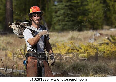 Stock Image - USA, Montana, Lakeside, portrait of lumberjack. Fotosearch
