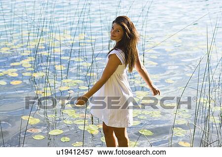USA, Montana, Portrait of teenage girl (16-17) at lakeside View Large Photo Image Stock Photo - USA, Montana, Portrait of teenage girl (16-17) at lakeside. Fotosearch