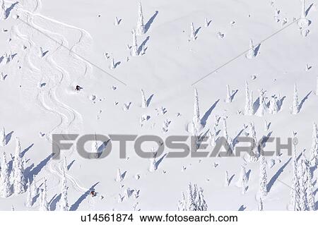 Picture - USA, Montana, Whitefish, aerial view of skiers on slope. Fotosearch