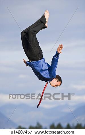 Stock Photo - USA, Montana, Whitefish, businessman mid-air. Fotosearch