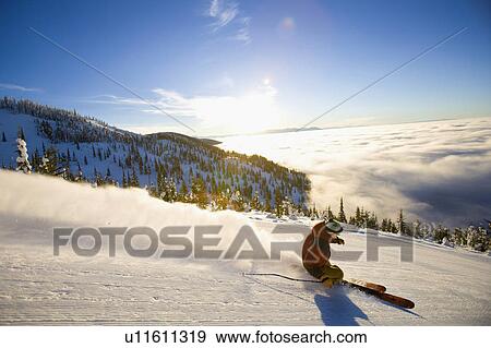 USA, Montana, Whitefish, Male skier on mountain slope at sunrise View Large Photo Image Stock Photo - USA, Montana, Whitefish, Male skier on mountain slope at sunrise. Fotosearch