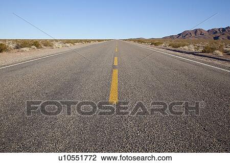 Stock Image - USA, Nevada, road through desert. Fotosearch