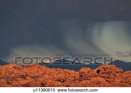 Stock Photography - USA, Nevada, Valley of Fire, storm cloud over rocks. Fotosearch