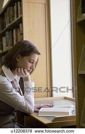 USA, New Jersey, female student reading book in library View Large Photo Image Stock Photo - USA, New Jersey, female student reading book in library. Fotosearch