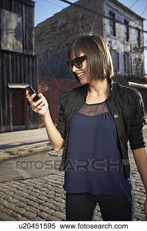 USA, New York City, Brooklyn, woman in street using phone View Large Photo Image Stock Photography - USA, New York City, Brooklyn, woman in street using phone. Fotosearch