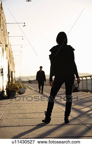 USA, New York City, Brooklyn, woman with bottle standing in street View Large Photo Image Stock Photo - USA, New York City, Brooklyn, woman with bottle standing in street. Fotosearch