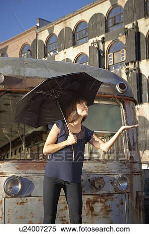 USA, New York City, Brooklyn, woman with umbrella checking for rain View Large Photo Image Stock Photography - USA, New York City, Brooklyn, woman with umbrella checking for rain. Fotosearch