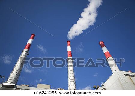 Stock Photography - USA, New York City, Factory chimneys against blue sky. Fotosearch