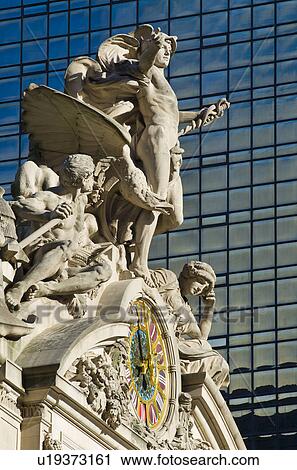 Stock Image - USA, New York City, Sculpture on top of Grand Central Station facade. Fotosearch