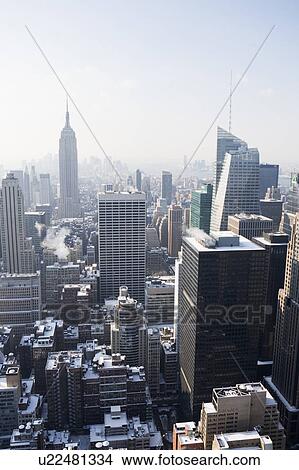 USA, New York City, View of Manhattan covered with snow, with Empire State Building in background View Large Photo Image Picture - USA, New York City, View of Manhattan covered with snow, with Empire State Building in background. Fotosearch