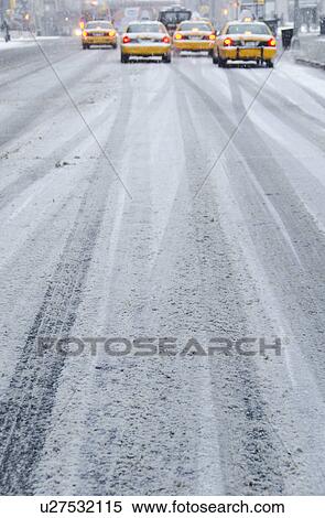 Stock Photography - USA, New York City, Yellow taxis in blizzard. Fotosearch