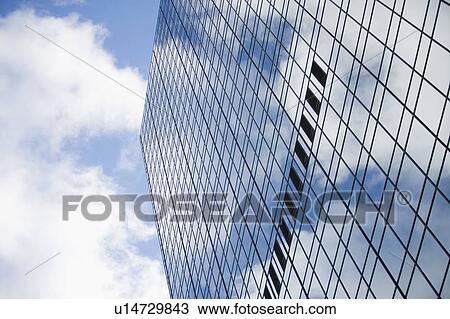 Stock Image - USA, New York State, New York City, Low angle view on glass skyscraper. Fotosearch